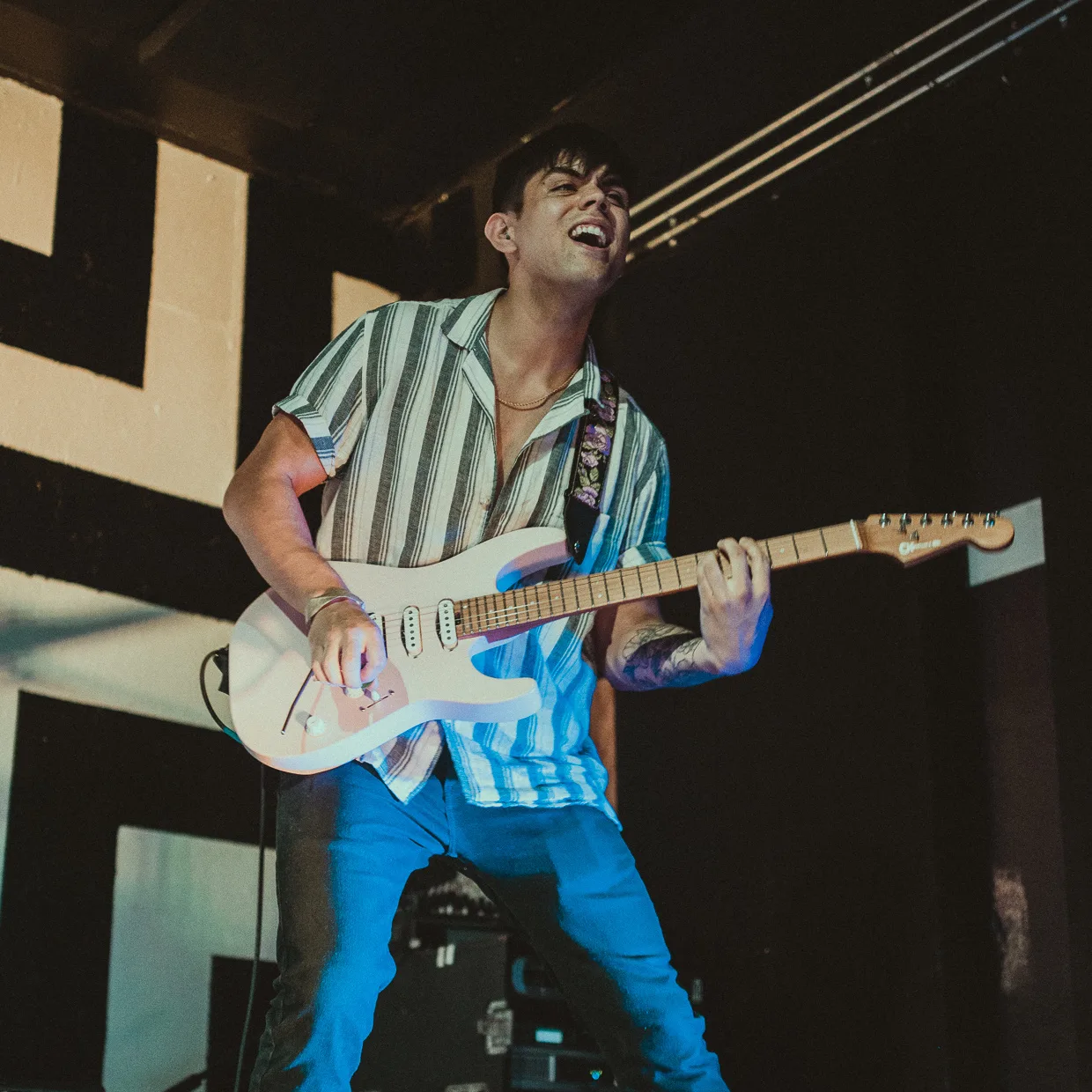 Luke laughing mid-solo on stage with a white Stratocaster